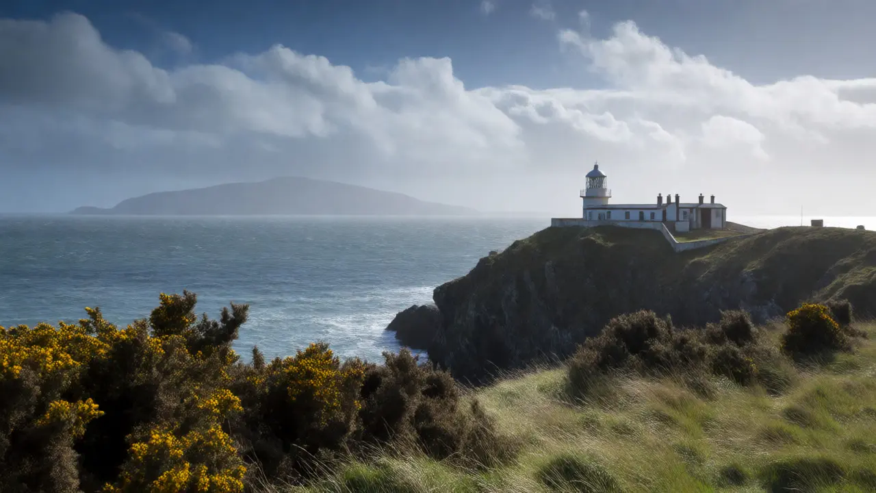 Turnberry lighthouse on rugged Ayrshire cliffs with Isle of Arran in the distance